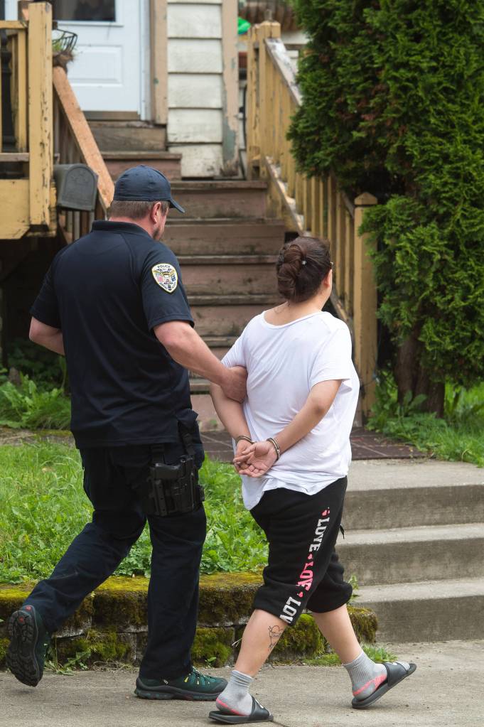 Juneau police question a woman found at James Barrett&rsquo;s house at 401 Harris Street on Tuesday, Aug. 29, 2017. (Michael Penn | Juneau Empire)