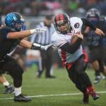 Thunder Mountain&rsquo;s Roy Tupou, left, chases Juneau-Douglas&rsquo; Liam Van Sickle at TMHS on Friday, Sept. 1, 2017. TMHS won 10-7 in overtime. (Michael Penn | Juneau Empire)
