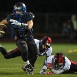 Thunder Mountain&rsquo;s Roy Tupou breaks tackle attempts by Juneau-Douglas at TMHS on Friday, Sept. 1, 2017. TMHS won 10-7 in overtime. (Michael Penn | Juneau Empire)