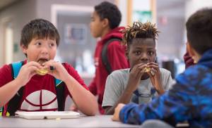 Kahyl Dybdahl, left, and Bronze Chevis eat an egg sandwich breakfast before school at Dzantik&rsquo;i Heeni Middle School on Wednesday, Sept. 6, 2017. The Juneau Community Foundation presented a check for $24,300 to Juneau School District for in-school food programs on Wednesday, Sept. 6, 2017. (Michael Penn | Juneau Empire)
