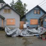 Two houses owned by Kathleen Barrett are shown boarded up on Friday, Sept. 8, 2017. Police were called after renters kicked one door in to gain access to the building. (Michael Penn | Juneau Empire)