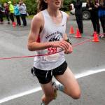 Arne Ellefson-Carnes crosses the finish line in first place for the Juneau-Douglas High School cross country team. (James Poulson | Sitka Sentinel)