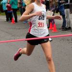 Sadie Tuckwood crosses the finish line in first place for the Juneau-Douglas High School cross country team. (James Poulson | Sitka Sentinel)