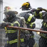 Capital City Fire/Rescue cleans up after fighting a fire at 526 Seward Street, next to the Terry Miller Legislative Building, on Sunday, Sept. 17, 2017.