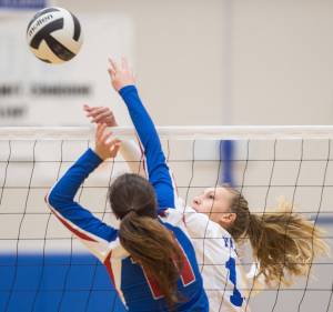 Thunder Mountain&rsquo;s Lilyan Smith tips the ball over against Sitka&rsquo;s Hadley Andersen at Thunder Mountain High School on Friday. (Michael Penn | Juneau Empire)