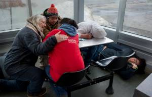In this March 25 photo, Cindy Dau, left, checks on homeless people sleeping in the downtown Transit Center. (Michael Penn | Juneau Empire File)