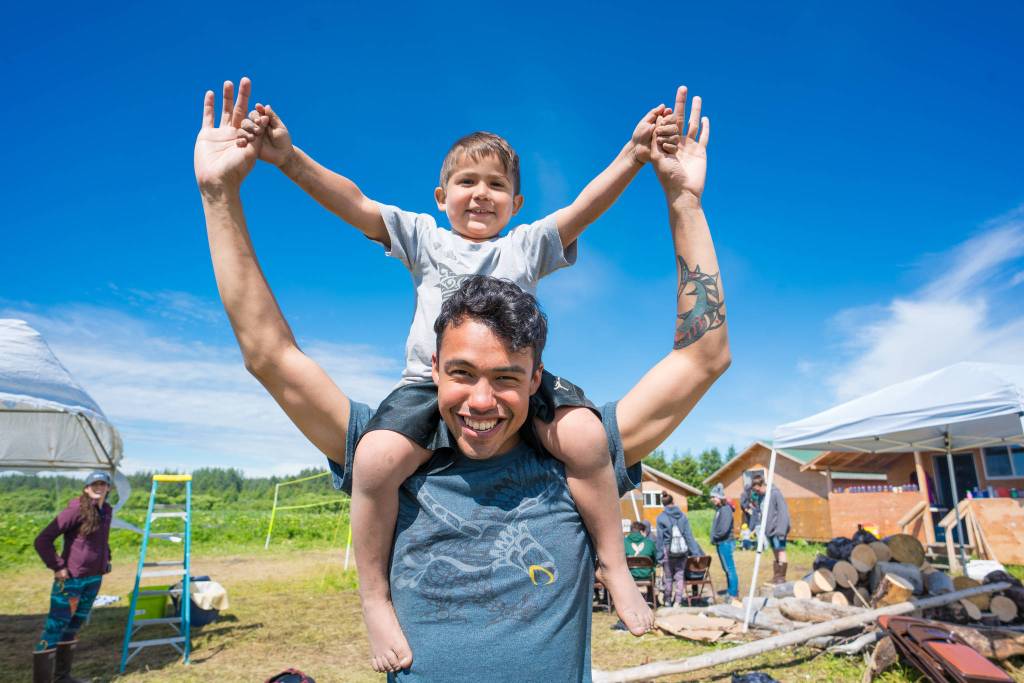 Two brothers check the dryfish. (Photo by Bethany Goodrich)