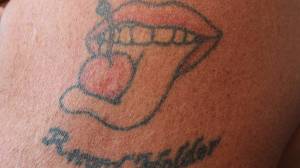 Al Gliniecki&rsquo;s tattoo of his trademarked logo of a cherry with its stem tied on an outstretched tongue. (Nolin Ainsworth | Juneau Empire)