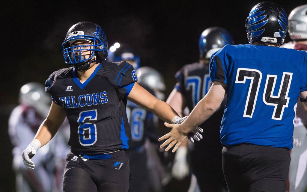Thunder Mountain&rsquo;s Roy Tupou, left, gets a congratulatory handslap from teammate AJ Huber after Tupou&rsquo;s touchdown against Ketchikan at TMHS on Friday, Sept. 22, 2017. TMHS won 28-0. (Michael Penn | Juneau Empire)
