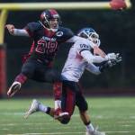 Juneau-Douglas&rsquo; Kasey Watts, left, bats a pass away from North Pole&rsquo;s Jamie Johnson at Adair-Kennedy Memorial Field on Saturday, Sept. 23, 2017. JDHS lost 16-22. (Michael Penn | Juneau Empire)