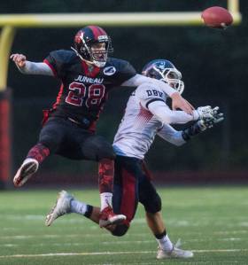 Juneau-Douglas&rsquo; Kasey Watts, left, bats a pass away from North Pole&rsquo;s Jamie Johnson at Adair-Kennedy Memorial Field on Saturday, Sept. 23, 2017. JDHS lost 16-22. (Michael Penn | Juneau Empire)