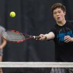 Sammy McKnight volleys against the mixed-doubles team of Madisyn Carter and Kolby Hoover as he is backed up by his partner, Adelie McMillian, during their Southeast Regional Tournament match at JRC/The Alaska Club on Thursday, Sept. 21, 2017. McKnight and McMillian won the match 8-4. (Michael Penn | Juneau Empire)