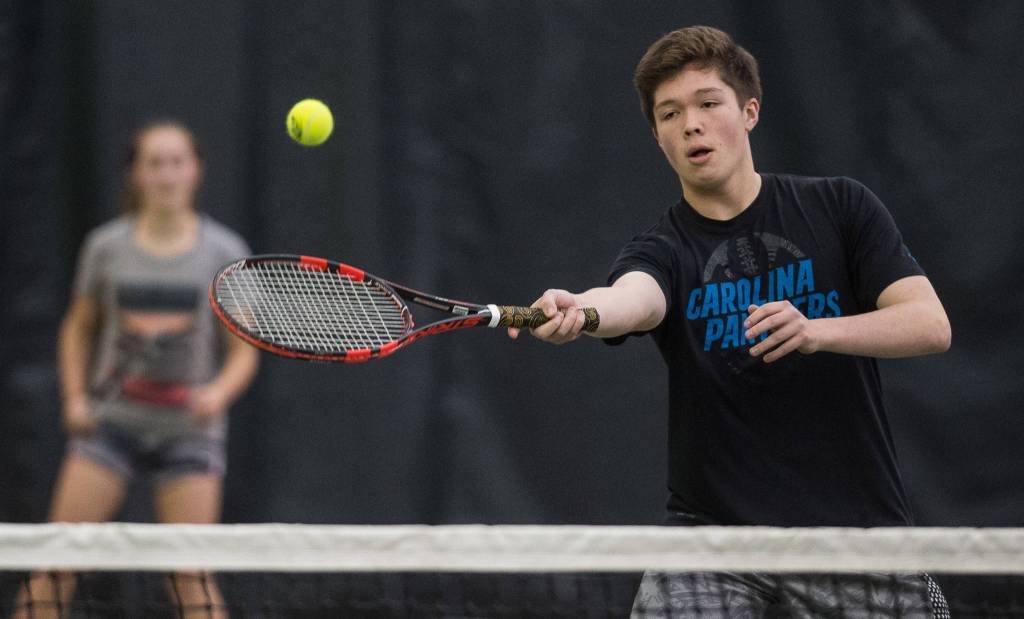 Sammy McKnight volleys against the mixed-doubles team of Madisyn Carter and Kolby Hoover as he is backed up by his partner, Adelie McMillian, during their Southeast Regional Tournament match at JRC/The Alaska Club on Thursday, Sept. 21, 2017. McKnight and McMillian won the match 8-4. (Michael Penn | Juneau Empire)
