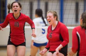 Juneau-Douglas&rsquo;s Jessica Peirce, left, and Abby Meiners celebrate at point against Thunder Mountain at TMHS on Tuesday, Sept. 26, 2017. JDHS won 15-13 in the tiebreaking fifth game. (Michael Penn | Juneau Empire)