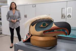 Coordinator Carmaleeda Estrada stands next to an eagle headdress by artist Duane Pasco at the Walter Soboleff Center on Wednesday, Sept. 27, 2017. The artwork is one of more than 50 pieces featured in Sealaska Heritage Institute&rsquo;s second Tin&