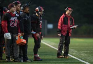 Juneau-Douglas High School football coach Kevin Hamrick, right, watches his team play against North Pole at Adair-Kennedy Memoiral Field on Saturday, Sept. 23, 2017. JDHS lost 22-16. (Michael Penn | Juneau Empire)