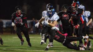 Thunder Mountain&rsquo;s Roy Tupou breaks a tackle against the Juneau-Douglas High School Saturday night at Adair Kennedy Memorial Field. Thunder Mountain won 26-8. (Konrad Frank | For the Juneau Empire)