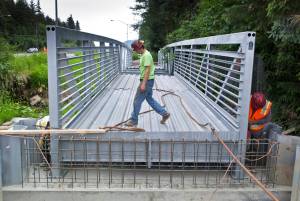 A Trucano Construction crew installs a 94-foot-long bridge over Jordan Creek next to Egan Drive in 2015. A ballot measure debated in Anchorage Superior Court on Tuesday would have significant implications for bridges and other projects that affect salmon-bearing streams.  Michael Penn | Juneau Empire file