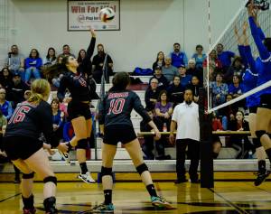 Juneau-Douglas High School&rsquo;s Leah Spargo (4) jumps for the spike as teammates Jessica Pierce (10) and Abby Meiners (16) watch in anticipation at Tuesday night&rsquo;s varsity volleyball game against the Thunder Mountain Falcons. (Lance Nesbitt | Juneau Empire)