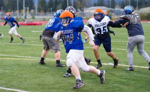 Defensive linemen rush at Thunder Mountain High School football practice at TMHS on Wednesday, Oct. 4, 2017. (Michael Penn | Juneau Empire)