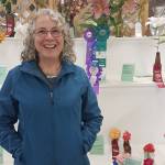 Nell McConahey at the Alaska State Fair with her award-winning lilies. McConahey won four awards at the Alaska State Fair this year: Best of Show, Judges Choice, first place for hybrid lilies and first place overall for lilies. (Courtesy photo)
