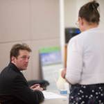 Christopher Strawn speaks with Juneau Assistant District Attorney Amy Paige at the start of his trial in Juneau Superior Court on Thursday, Oct. 5, 2017. Strawn, 34, faces charges of first-degree and second-degree murder, manslaughter, criminally negligent homicide, third-degree assault and weapons misconduct in the shooting death of Brandon Cook in October 2015. (Michael Penn | Juneau Empire)