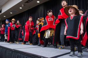 Natalie Soto, 2, helps sing with the All Nations Children Dancers as Juneau residents celebrate Indigenous Peoples Day at Elizabeth Peratrovich Hall on Monday, Oct. 9, 2017. (Michael Penn | Juneau Empire)
