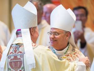 Bishop Andrew E. Bellisario, right, is greeted by Bishop Edward J. Burns during his ordination as the Sixth Bishop of the Diocese of Juneau at St. Paul the Apostle Catholic Church on Tuesday, Oct. 10, 2017. Burns was the Diocese&rsquo;s Fifth Bishop and is now the Bishop of Dallas. (Michael Penn | Juneau Empire)
