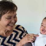 Evelyn Capisos, mother of Lory Rowe, gets a smile out of Liam at their Mendenhall Valley home on Tuesday, Oct. 10, 2017. Liam is one of identical triplets born on April 23, 2017, to parents John David and Lory Rowe.