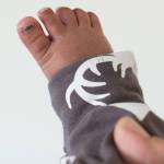 Liam David has his toenail painted green to identify him from his two brothers. The identical triplets born on April 23, 2017, to parents John David and Lory Rowe. They were photographed at their Mendenhall Valley home on Tuesday, Oct. 10, 2017.