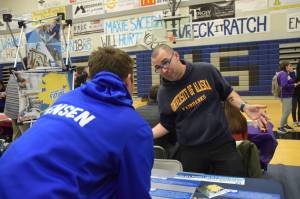 Kevin Gullufsen | Juneau Empire TMHS sophomore Cole Jensen talks with a representative from the University of Alaska Fairbanks&rsquo; engineering program on Friday&rsquo;s college and career fair at TMHS.