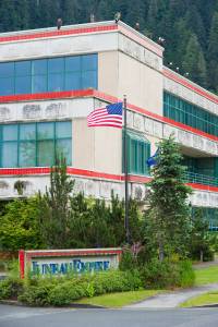 Ten bald eagles perch on top of the Juneau Empire building as they watch salmon return to the nearby fish hatchery on Wednesday, July 11, 2012.  ^ Michael Penn | Juneau Empire File