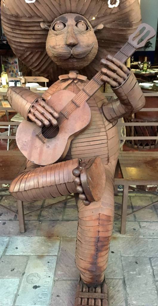 A wooden sculpture along a marina seawalk. Photo by Denise Carroll.