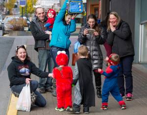 Parents, grandparents and friends have fun photographing their young ones on Seward Street for Halloween 2016. More than 50 businesses downtown welcomed trick-or-treaters last year. (Michael Penn | Juneau Empire)