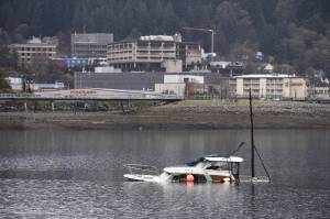 A derelict vessel is submerged in Gastineau Channel near the Douglas Bridge on Oct. 23, 2017. (Michael Penn | Juneau Empire)