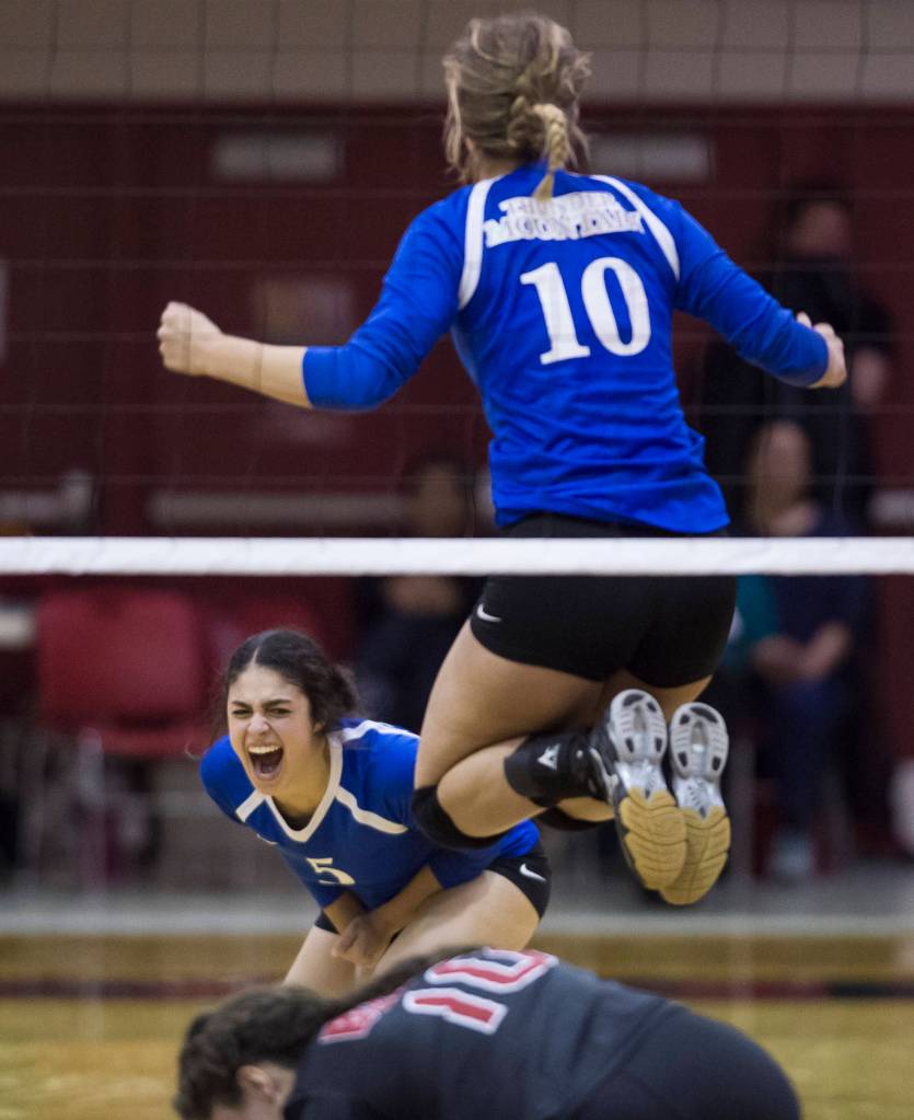 Thunder Mountain&rsquo;s Maximina Saceda-Hurt, left, and Emma Kaelke celebrate their win against Juneau-Douglas at JDHS on Friday, Oct. 27, 2017. Thunder Mountain won 16-14 in the tie-breaking fifth game. (Michael Penn | Juneau Empire)