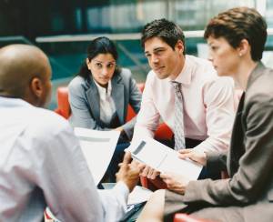 Business people gather for a meeting. (Photo courtesy of Thinkstock)