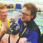Thunder Mountain High School swim and dive head coach Josiah Loseby is congratulated by his team after the boys won first in the ASAA/First National Bank Alaska State Swim and Dive Championships on Saturday, Nov. 4. (Michael Dinneen | For the Juneau Empire)