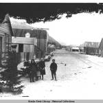 This street scene in Dyea shows the false front as the small building on the left. From the Paul Sinic Collection, identifier ASL-P75-072. (Photo courtesy of the Alaska Historical Archives)