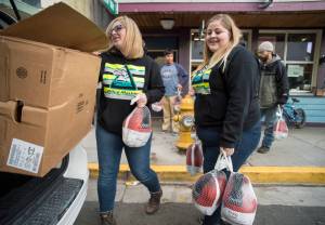 Cassandra Strahin, left, and Nicole Huntsman, of Allen Marine, deliver 30 frozen turkeys to the Glory Hole on Monday, Nov. 6, 2017. (Michael Penn | Juneau Empire)