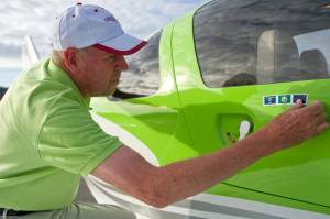In this September 2014 photo, Field Morey, an FAA-Certified Flight Instructor from Medford, Oregon, applies an Alaskan flag sticker to the side of his 2013 Cessna Corvalis TTx four- passenger airplane after landing in Juneau. (Michael Penn | Juneau Empire File)