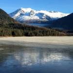 Mendenhall Glacier reflects in the thin ice of Mendenhall Lake. (Photo by Denise Carroll)