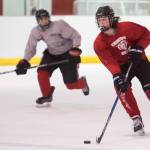 Cameron Smith, right, brings the puck up with Joseph Monsef during Juneau-Douglas High School hockey practice at the Treadwell Arena on Thursday, Nov. 16, 2017. (Michael Penn | Juneau Empire)