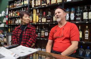 Oke and Robert Rodman talk about their experiences of owning and operating Percy&rsquo;s Liquor on Front Street on Friday, Nov. 17, 2017. They are closing the business after 30 years. (Michael Penn | Juneau Empire)