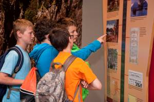Visiting students examine the Haa Aani panel during a visit to Sealaska Heritage. (Courtesy Photo | Brian Wallace via Sealaska Heritage Institute)