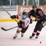 Juneau-Douglas&rsquo; Cully Corrigan, left, competes for the puck against Kenai&rsquo;s Jude Gabriel in Juneau-Douglas&rsquo;s first home match of the season at Treadwell Arena on Friday, Nov. 17, 2017. (Michael Penn | Juneau Empire)