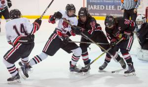 Juneau-Douglas&rsquo; Dalton Hoy, center, competes for the puck against Kenai&rsquo;s Devin Every and Matt Hagel, right, in Juneau-Douglas&rsquo;s first home match of the season at Treadwell Arena on Friday, Nov. 17, 2017. (Michael Penn | Juneau Empire)