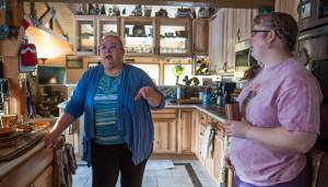 Sandy Frickey , left, talks about new assistive technology being used at home to help Frickey&rsquo;s daughter, Gina, be safe. (Michael Penn | Juneau Empire)