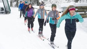 Juneau Nordic Ski Team members Erin Wallace, front, leads Aaron Blust and Anna Iverson in a pole-less skiing drill through fresh snow on Saturday, Nov. 18, 2017, at the Mendenhall Campgrounds. The JNST attended a Thanksgiving clinic in Anchorage Nov. 24-26 with teams from Nome and Unalakleet and led by two-time Olympian Lars Flora. (Nolin Ainsworth | Juneau Empire)