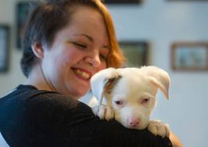 Briana Brint, president of Southeast Alaska Organization for Animals, holds Sid who is blind and deaf at a animal foster home in Juneau on Thursday, Nov. 30, 2017. Sid is from a litter rescued from Prince of Wales by the organization. (Michael Penn | Juneau Empire)